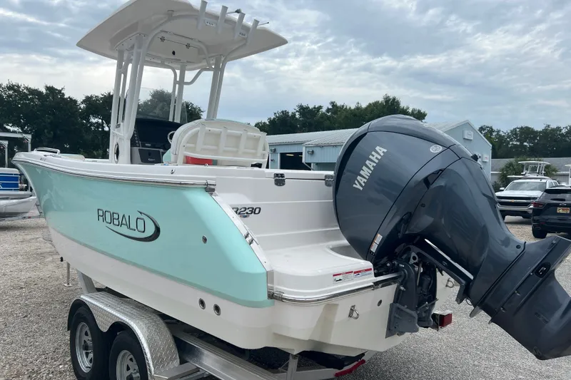 Slide: The Image of 2025 Robalo R230 Center Console boat with Yamaha engine on trailer. - 5