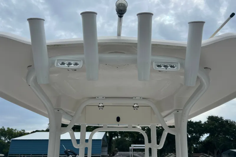 Slide: The Image of 2025 Robalo R230 Center Console boat with rod holders and LED lights on the T-top. - 9