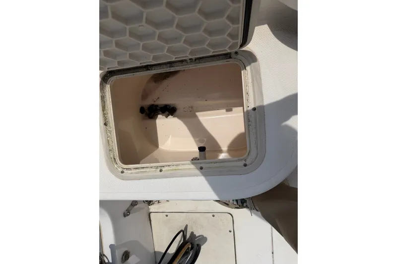 Slide: The Image of Open storage compartment on a 2005 McKee Craft Marathon 172 CC boat. - 12