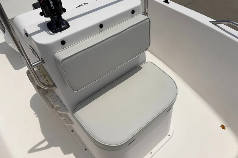 Slide: The Image of 2005 McKee Craft Marathon 172 CC boat seat with white cushioned backrest and storage. - 11