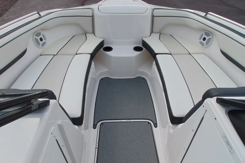 Slide: The Image of 2018 Yamaha Boats SX210 interior with white cushioned seating and integrated speakers. - 12
