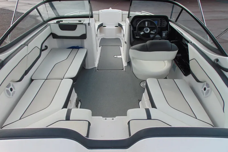 Slide: The Image of 2018 Yamaha Boats SX210 interior with spacious seating and modern dashboard design. - 9