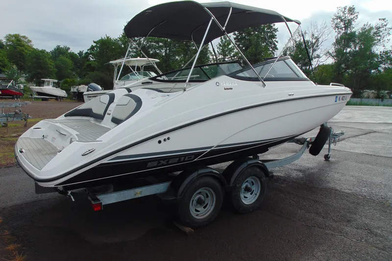 Slide: The Image of 2018 Yamaha Boats SX210 on trailer, parked outdoors with canopy. - 3