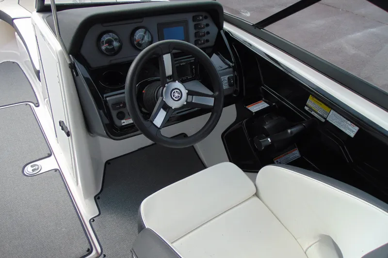 Slide: The Image of 2018 Yamaha Boats SX210 cockpit with steering wheel and dashboard controls. - 10