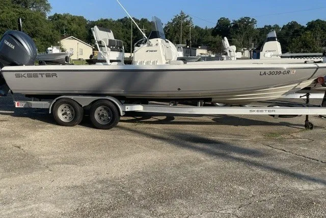 Slide: The Image of 2024 Skeeter SX241 boat on trailer, parked outdoors, featuring Yamaha engine. - 7