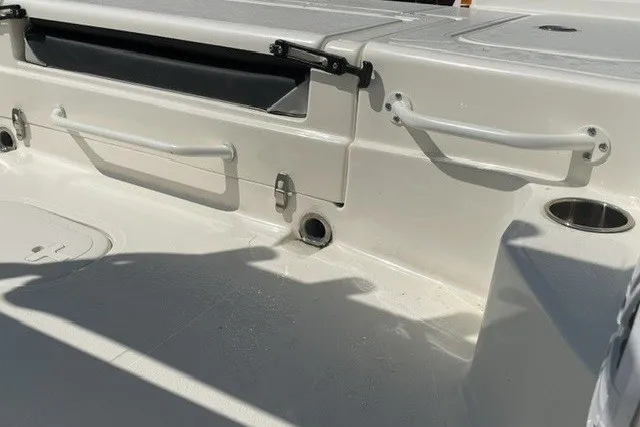 Slide: The Image of 2024 Skeeter SX241 boat interior with storage compartments and rod holders. - 1
