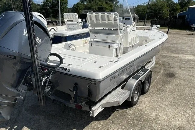 Slide: The Image of 2024 Skeeter SX241 boat on trailer, featuring Yamaha engine, parked outdoors. - 4