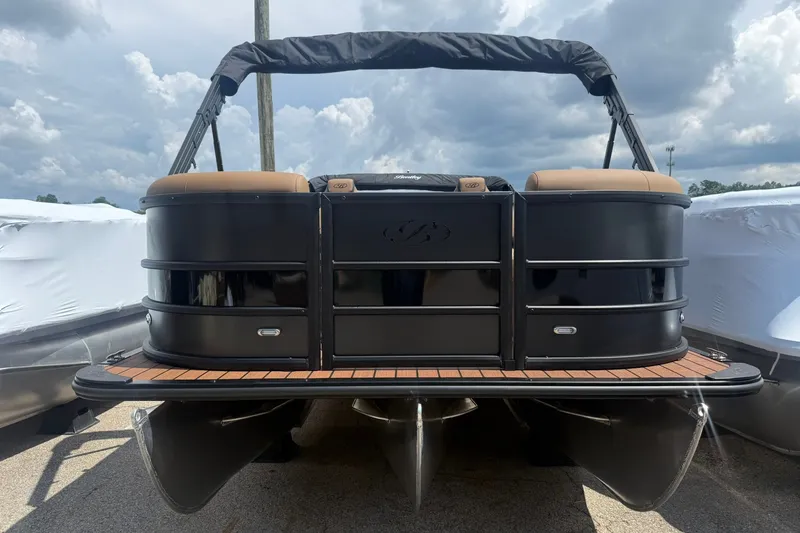 Slide: The Image of 2026 Bentley Pontoons Legacy 223 Swingback, sleek black design, docked under cloudy sky. - 4