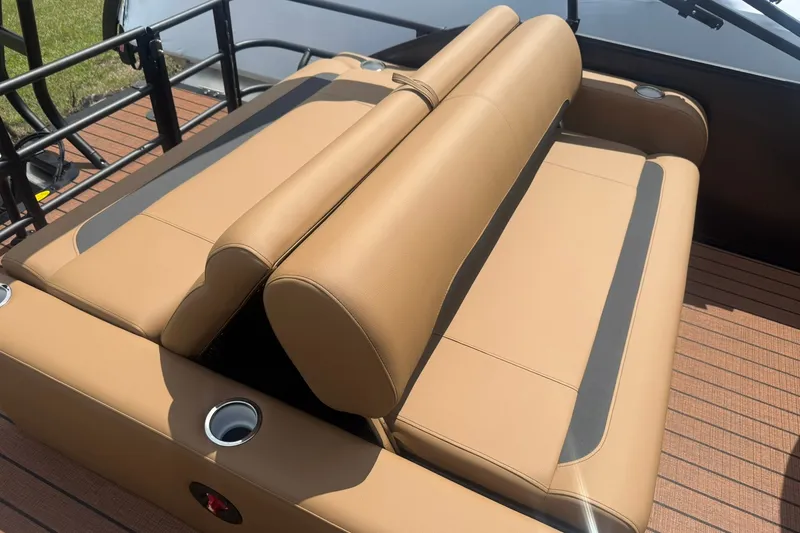 Slide: The Image of 2026 Bentley Pontoons Legacy 223 Swingback tan seating with cup holders on a boat deck. - 14