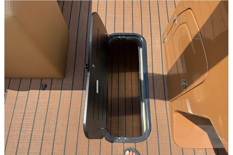 Slide: The Image of Open storage compartment on 2026 Bentley Pontoons Legacy 223 Swingback deck. - 16