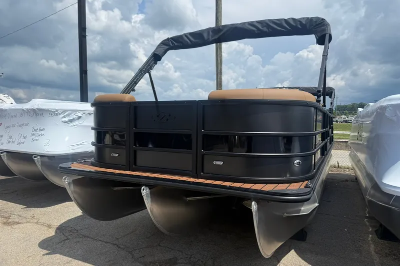 Slide: The Image of 2026 Bentley Pontoons Legacy 223 Swingback, black exterior, docked under cloudy sky. - 5