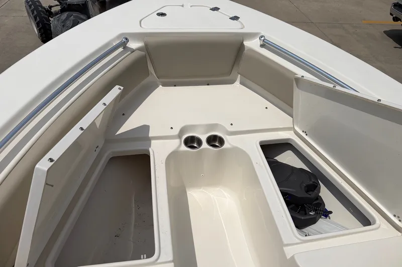 Slide: The Image of 2023 Key West 219 FS boat interior with storage compartments and cup holders. - 16