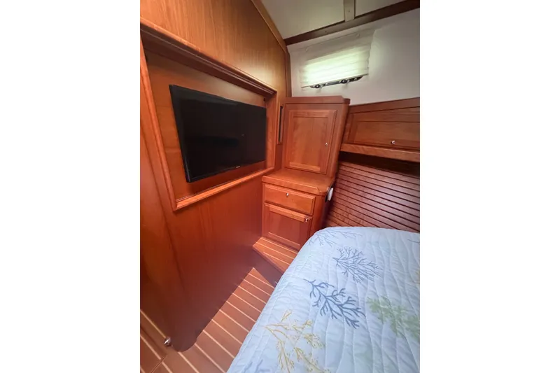 Slide: The Image of Interior of 2015 Sabre 38 Salon Express with wood cabinetry and mounted TV. - 37