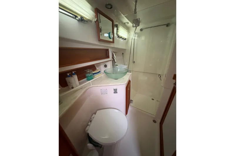 Slide: The Image of Bathroom interior of 2015 Sabre 38 Salon Express yacht, featuring modern fixtures and glass shower. - 31