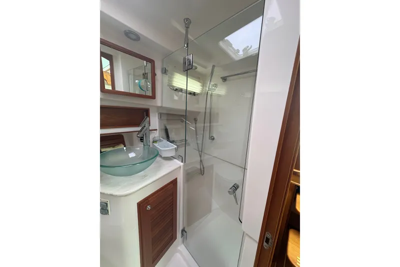 Slide: The Image of Luxurious bathroom in 2015 Sabre 38 Salon Express yacht with glass shower and modern sink. - 29