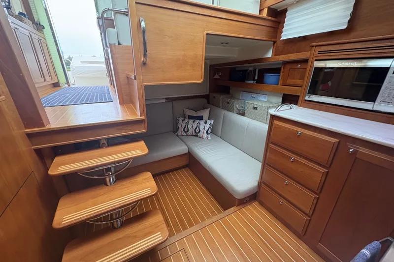 Slide: The Image of Interior of 2015 Sabre 38 Salon Express yacht with wooden cabinetry and cozy seating area. - 26