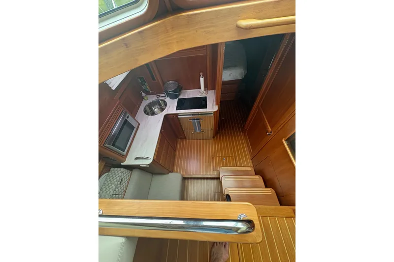 Slide: The Image of Interior view of 2015 Sabre 38 Salon Express yacht kitchen area with wooden finish. - 24