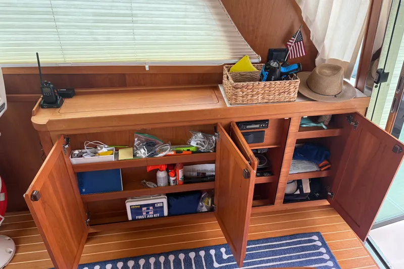 Slide: The Image of 2015 Sabre 38 Salon Express interior with open wooden cabinets and nautical accessories. - 20