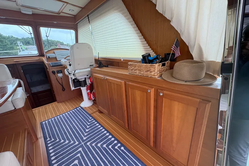Slide: The Image of Interior of 2015 Sabre 38 Salon Express with wooden cabinetry and nautical decor. - 19