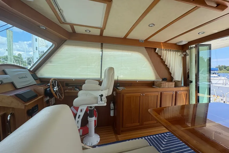 Slide: The Image of Interior of 2015 Sabre 38 Salon Express yacht with helm and seating area. - 22