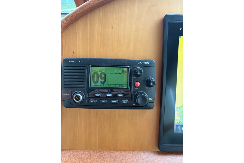 Slide: The Image of VHF radio and navigation display on 2015 Sabre 38 Salon Express boat. - 42
