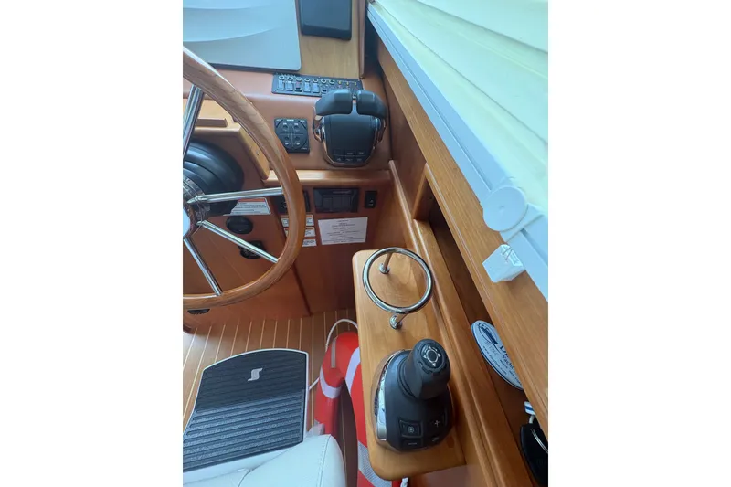 Slide: The Image of Helm of 2015 Sabre 38 Salon Express with wooden steering wheel and controls. - 46