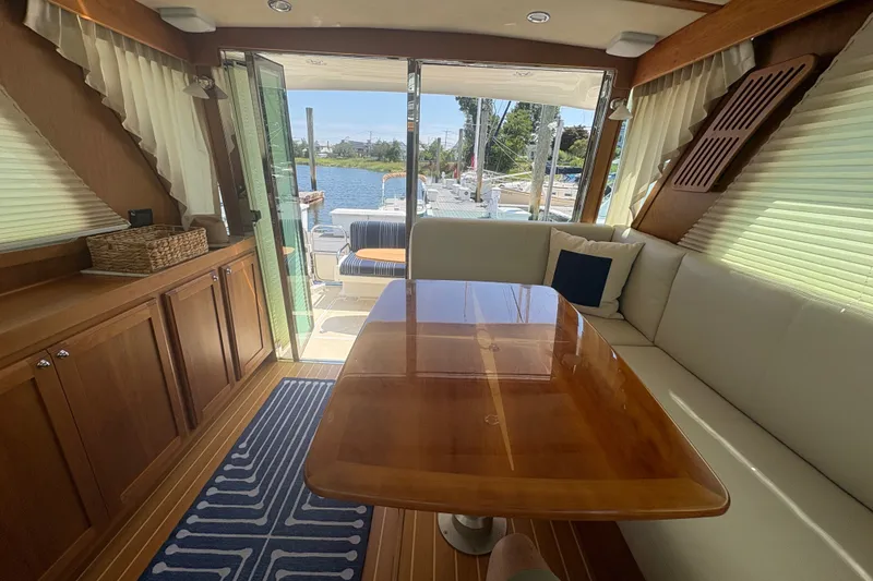 Slide: The Image of Interior of 2015 Sabre 38 Salon Express yacht with wooden table and seating. - 18