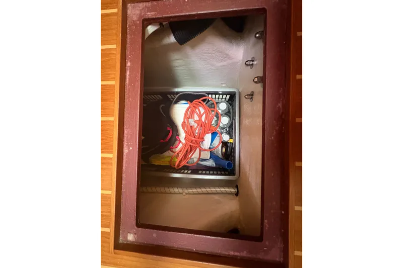 Slide: The Image of Storage compartment on 2015 Sabre 38 Salon Express with tools and cables. - 39