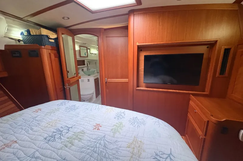 Slide: The Image of Interior of 2015 Sabre 38 Salon Express with wood paneling and cozy bedding. - 36
