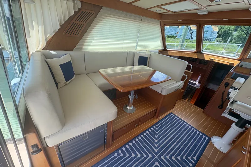 Slide: The Image of Interior of 2015 Sabre 38 Salon Express with elegant seating and wooden table. - 15