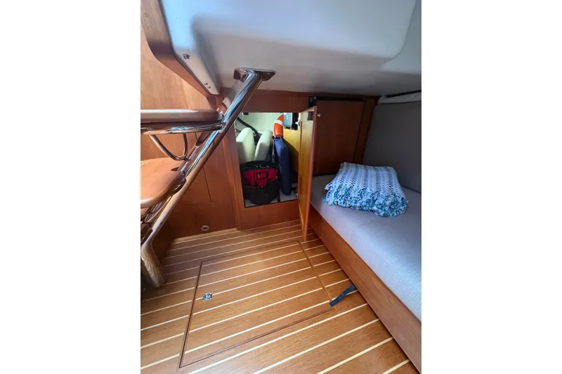 Slide: The Image of 2015 Sabre 38 Salon Express cabin interior with wooden flooring and cozy bedding. - 28