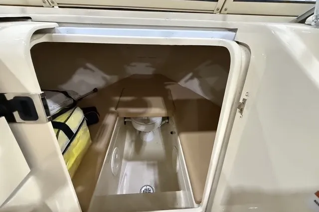 Slide: The Image of Interior view of 2023 Rossiter 23 boat storage compartment with seating and equipment. - 17