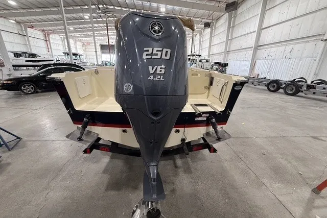 Slide: The Image of 2023 Rossiter 23 boat with Yamaha 250 V6 engine in a spacious warehouse. - 5