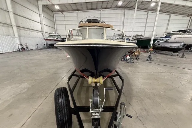 Slide: The Image of 2023 Rossiter 23 boat on trailer in spacious indoor storage facility. - 4