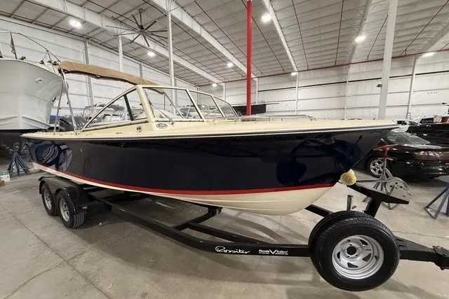 Slide: The Image of 2023 Rossiter 23 boat on trailer in indoor storage facility. - 2