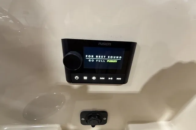 Slide: The Image of Fusion audio system display in a 2023 Rossiter 23 boat, featuring sound settings. - 16