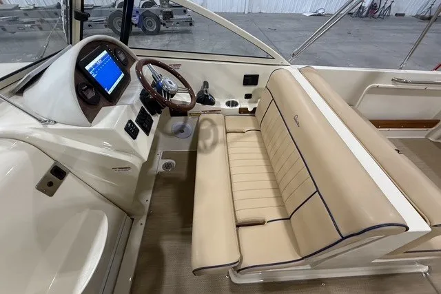 Slide: The Image of 2023 Rossiter 23 boat interior with beige seating and modern dashboard. - 12