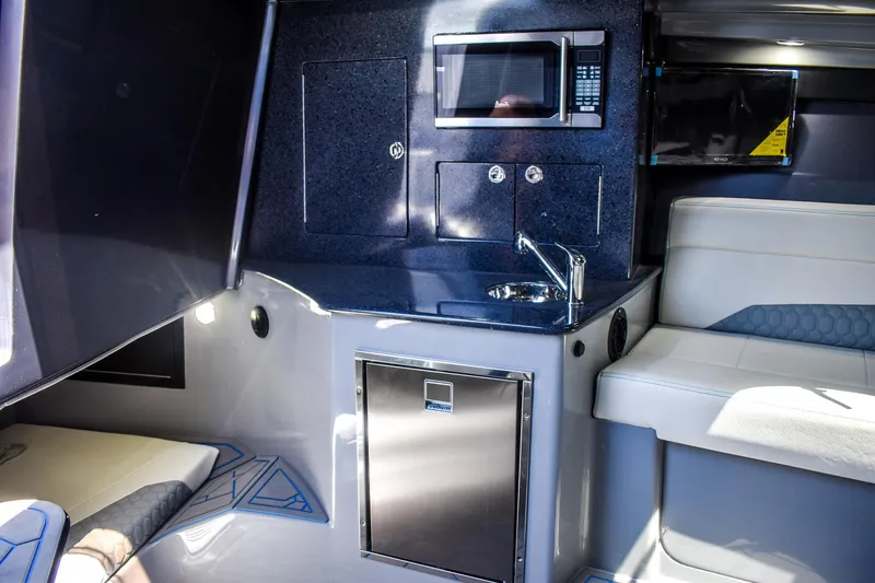 Slide: The Image of Interior of a modern boat cabin with sink, microwave, and seating area. - 16