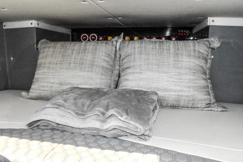 Slide: The Image of The 2022 Deep Impact 399 Forward Cabin features gray pillows and a blanket. - 19