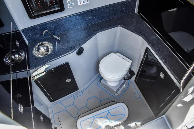 Slide: The Image of Interior of a modern boat cabin with toilet and sink, featuring a sleek design. - 17