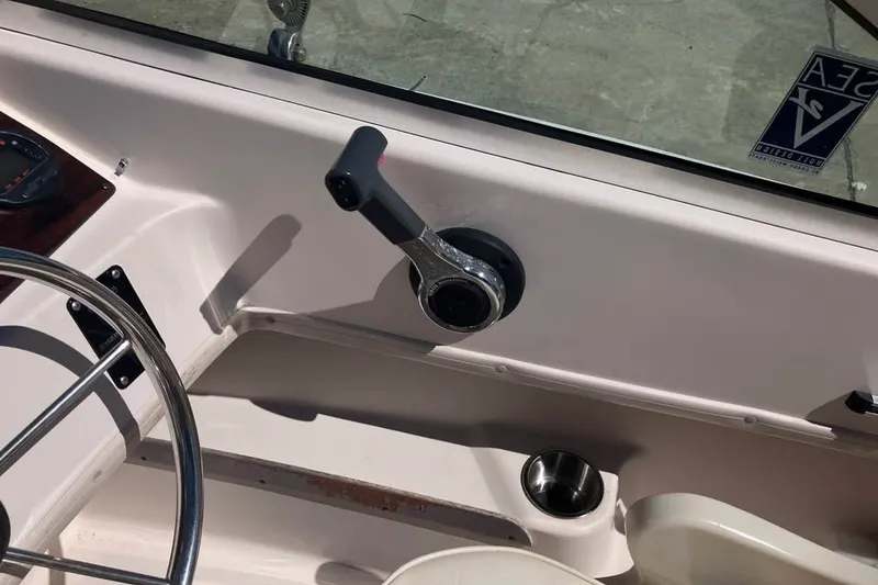 Slide: The Image of 1998 Grady-White Tournament 192 boat cockpit with steering wheel and throttle control. - 13