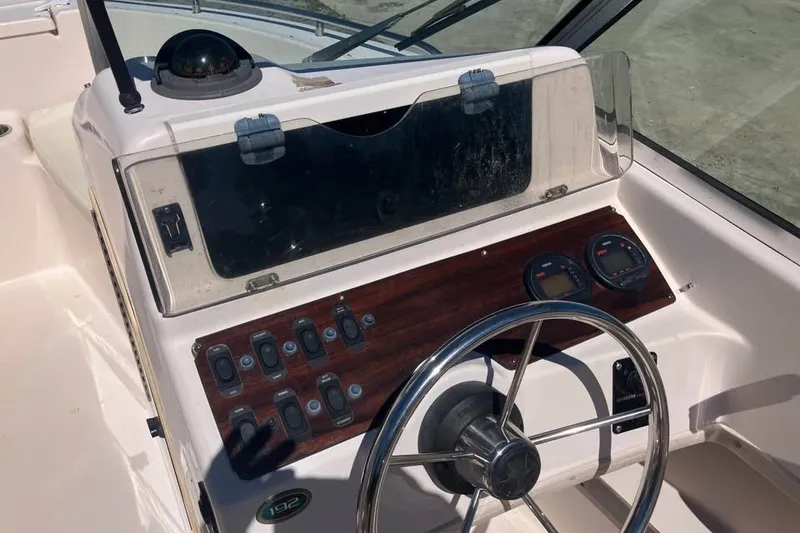 Slide: The Image of 1998 Grady-White Tournament 192 boat dashboard with steering wheel and control panel. - 11