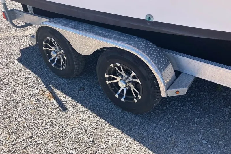 Slide: The Image of Trailer wheels of a 1998 Grady-White Tournament 192 boat on gravel. - 7