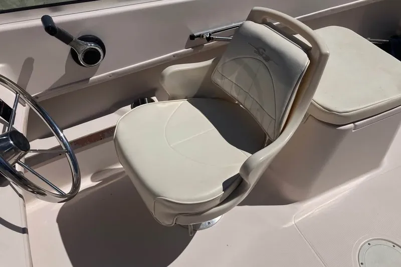 Slide: The Image of 1998 Grady-White Tournament 192 boat interior with steering wheel and cushioned seat. - 12