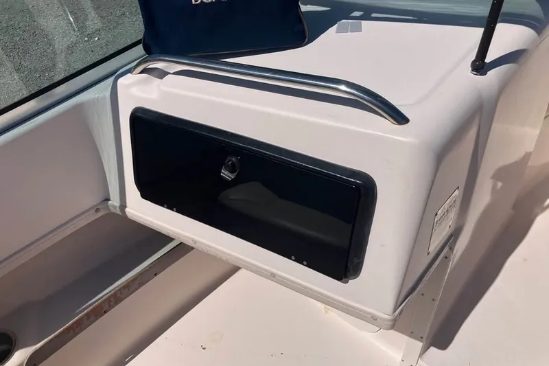 Slide: The Image of 1998 Grady-White Tournament 192 boat interior with storage compartment and railing. - 10