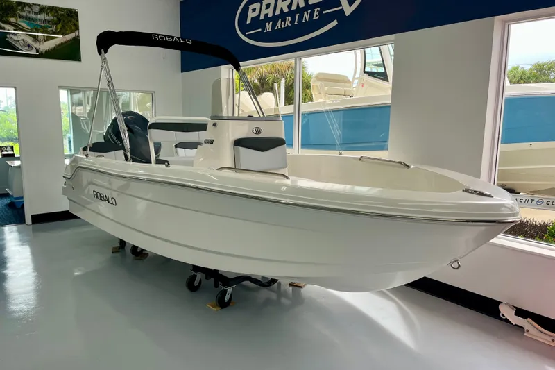 The Image of 2026 RO r160 boat displayed indoors at a marine showroom. - 1