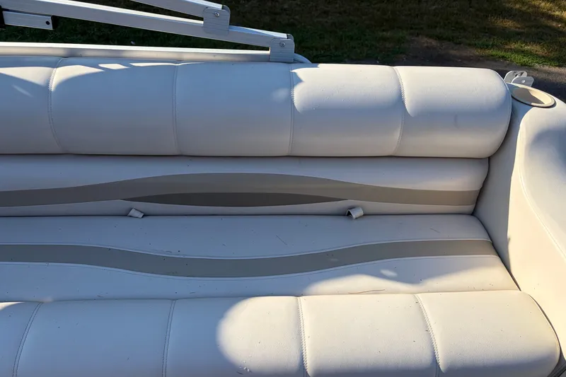 Slide: The Image of White cushioned seating on a 1984 Ercoa Captain 21 boat, outdoor setting. - 8