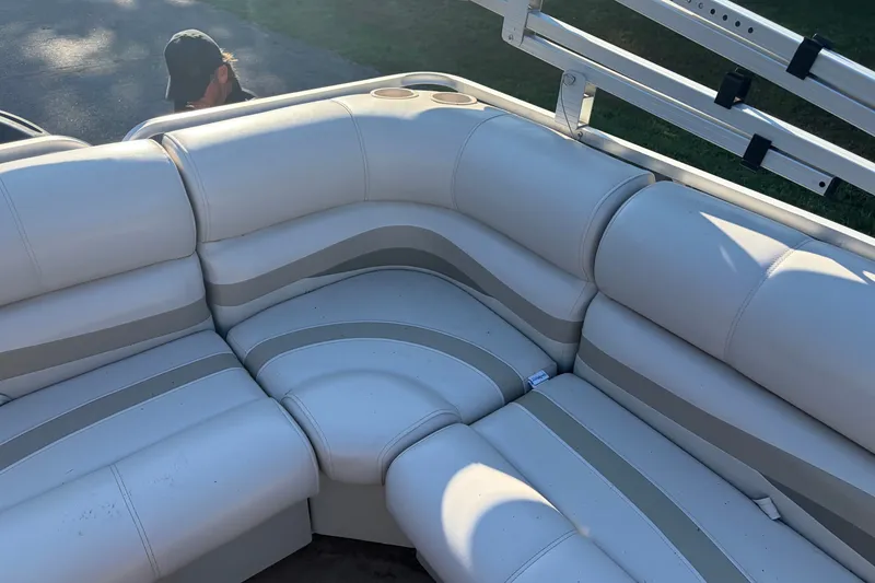 Slide: The Image of 1984 Ercoa Captain 21 boat interior with white cushioned seating and cup holders. - 10