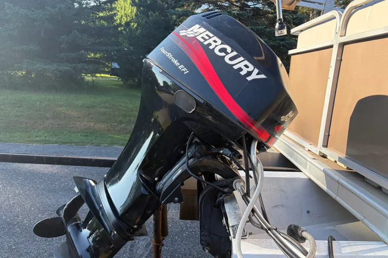 Slide: The Image of 1984 Ercoa Captain 21 with Mercury FourStroke EFI outboard motor, parked outdoors. - 11
