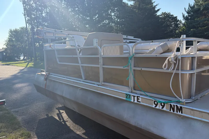 Slide: The Image of 1984 Ercoa Captain 21 pontoon boat parked on a sunny street. - 1